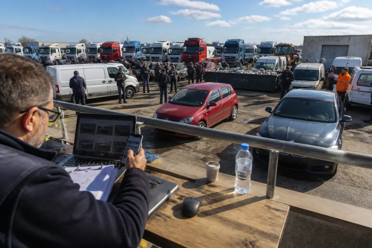 Auction participants view vehicles from a balcony at Pasco auctions gathering