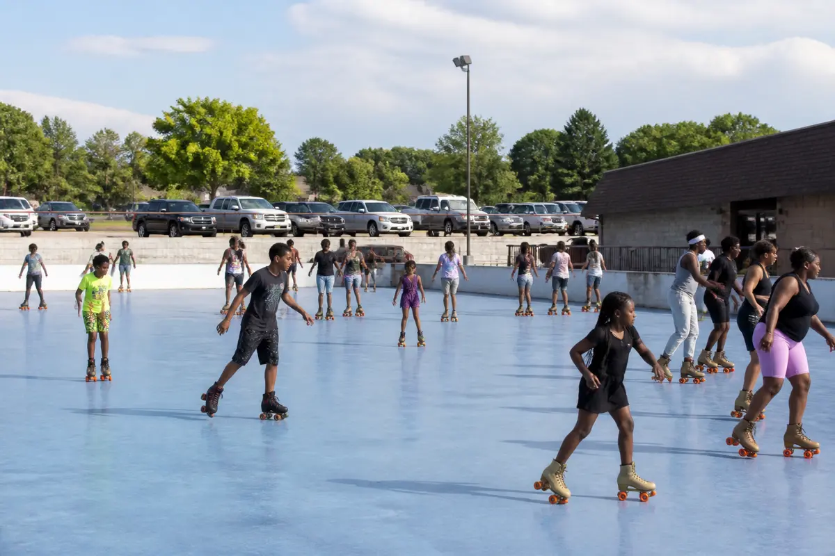 People roller skating outdoors at Skateland in Waukesha on a sunny day